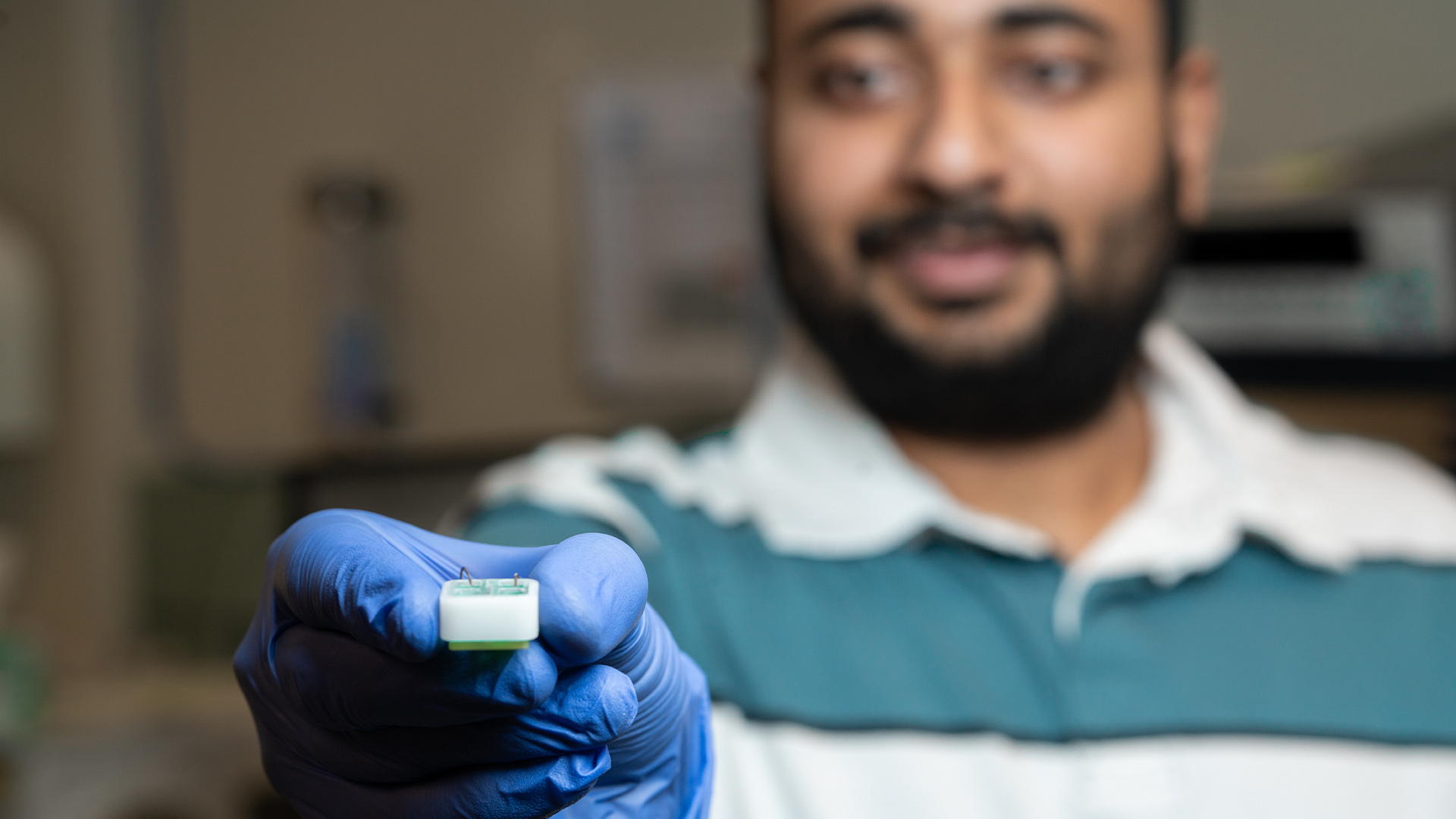 PhD researcher Shankar Dutt holding the ANU-developed technology into the camera