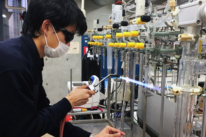 Research intern Matthew Teh working as a radiocarbon scientist fashion in the AORI sample preparation lab