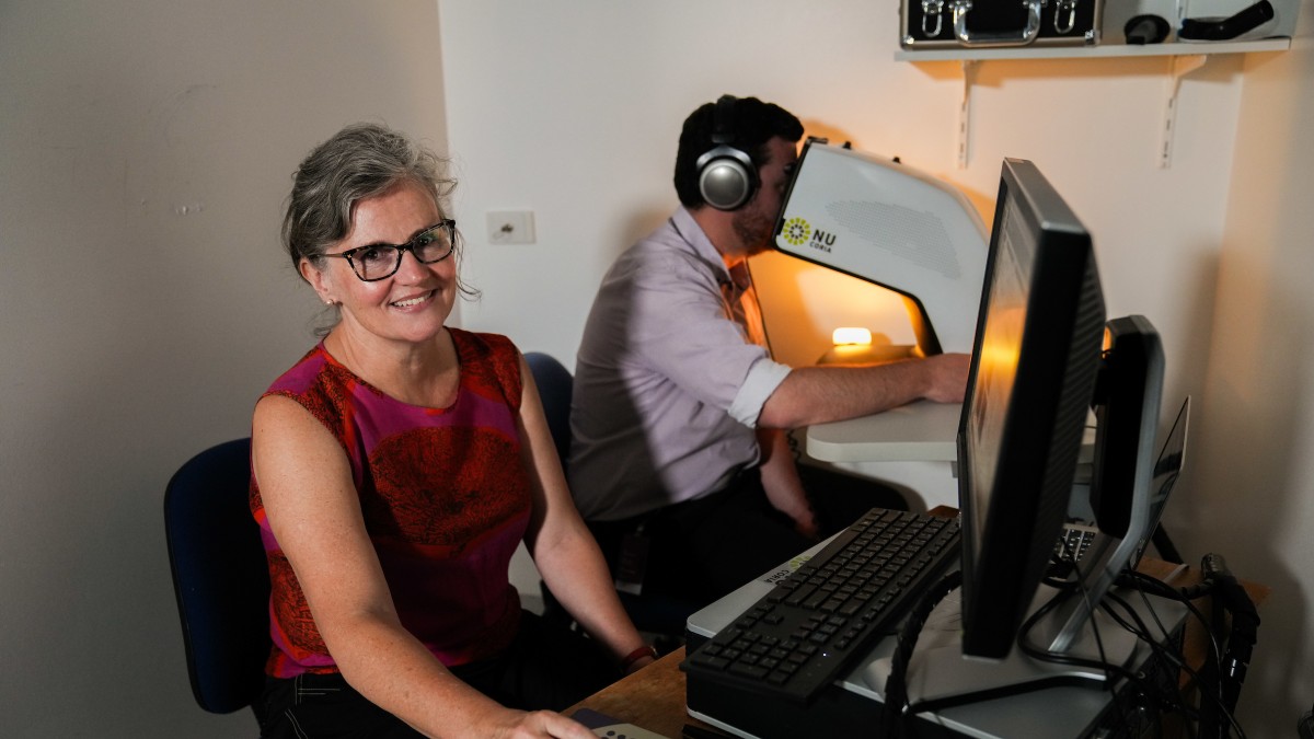 Sarah Mann sits at her computer while a student completes her pupilometry study. 