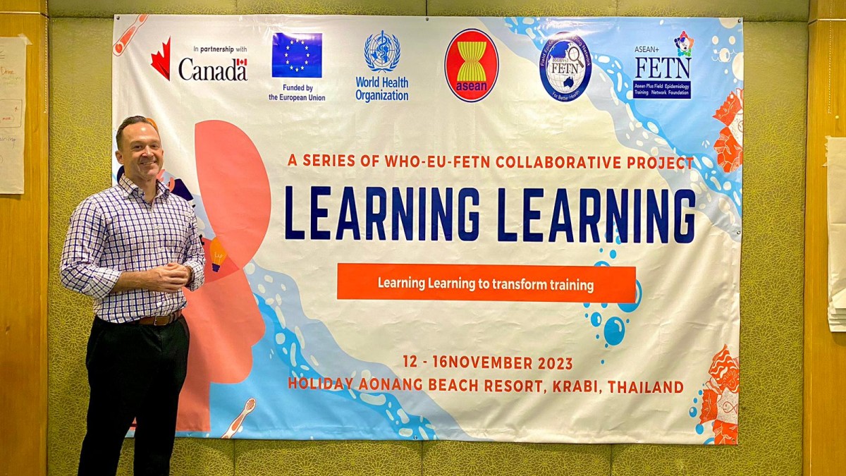 Matthew Griffith in front of a &#039;Learning learning&#039; banner.