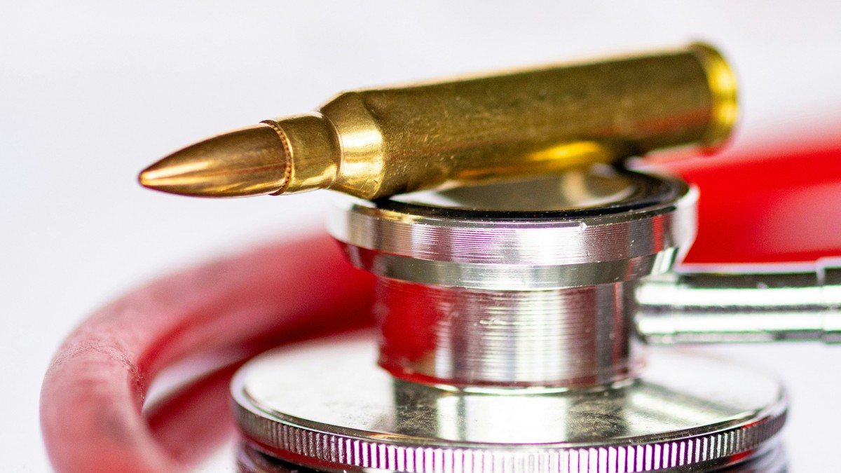 Bullet sitting on top of a stethoscope