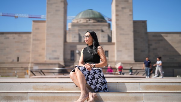 Maureen Montalban sits on the step of the Australian War Memorial.