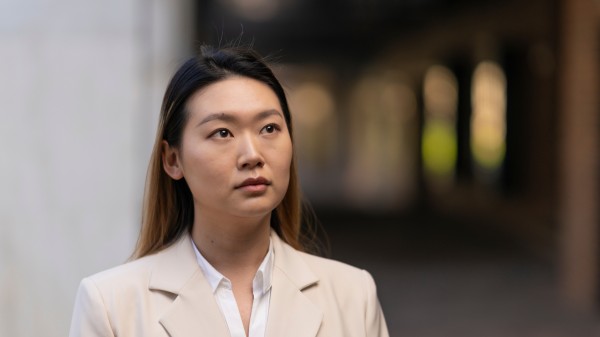 PhD candidate at the School of Medicine and Psychology, Yangxueqing (Mary) Jiang standing outside the Psychology building at the Australian National University 