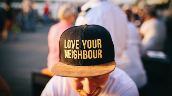 Man wearing a hat that says Love Your Neighbour
