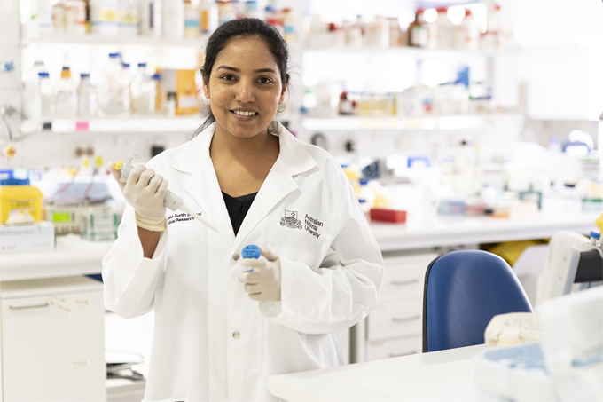PhD student Thilaga Velusamy holding a pipette